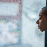 woman staring out window