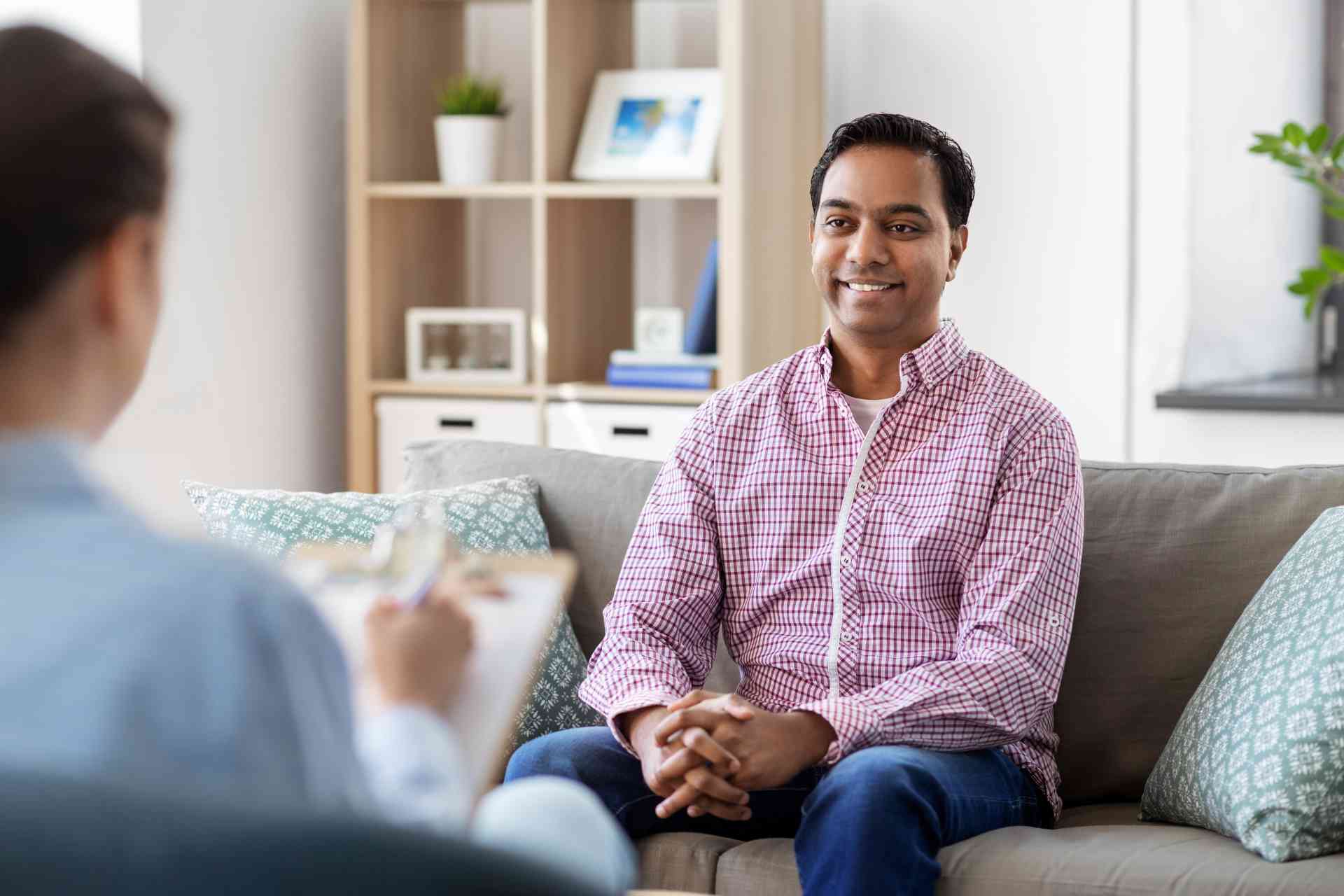 Man speaking with therapist during outpatient depression treatment session