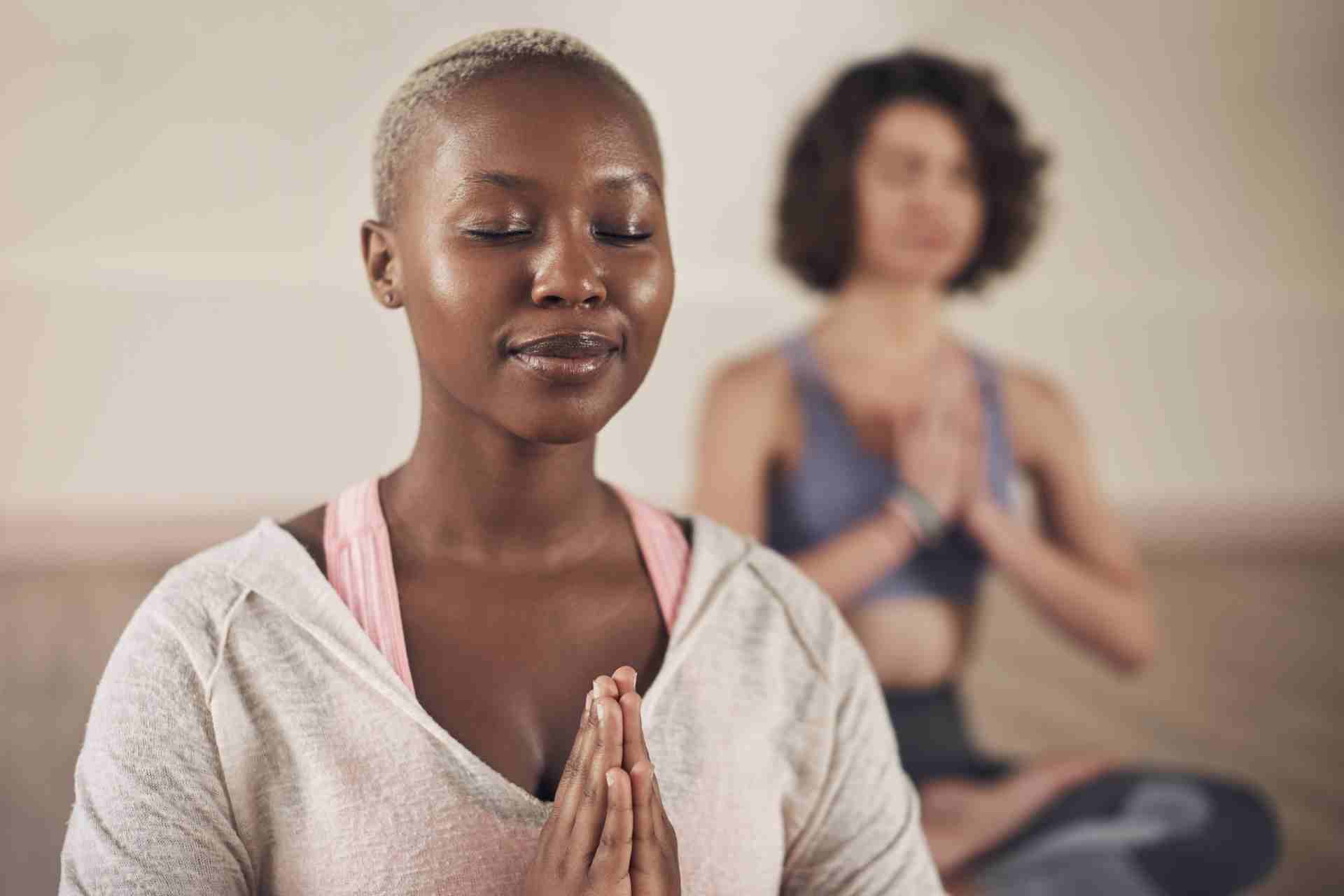 Woman practicing mindfulness meditation during a holistic mental health therapy session