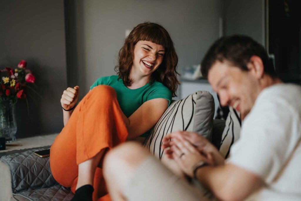 Two people connecting and laughing during anxiety recovery