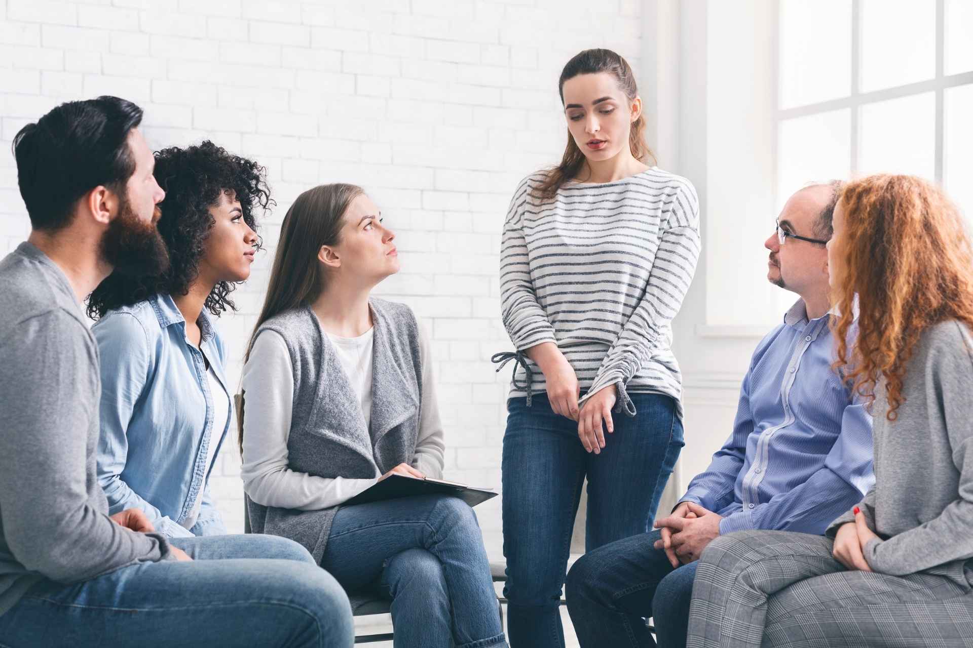 Adults participating in an intensive outpatient group therapy session.