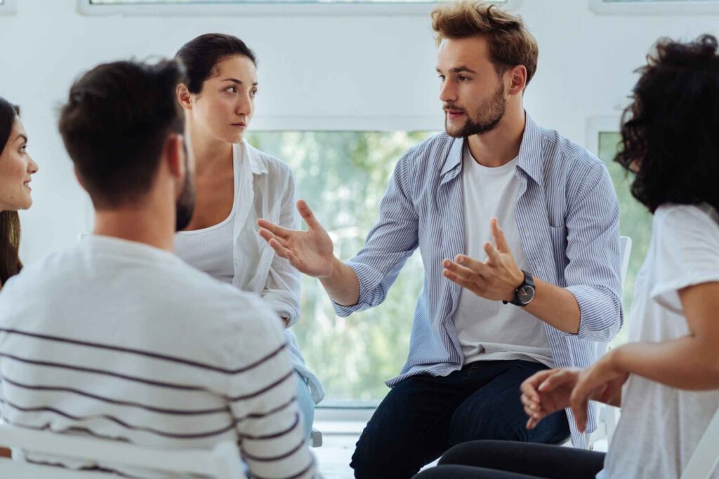 Adults discussing mental health concerns during a group therapy session