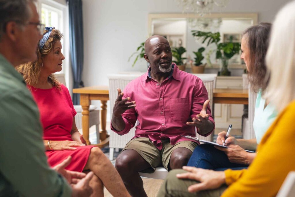 Adults sharing experiences during a mental health group therapy session