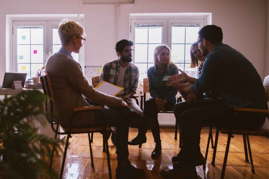 Mental health treatment team discussing goals and care planning with clients.